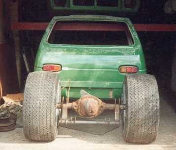 Rear axle, wheels and tyres behind the car