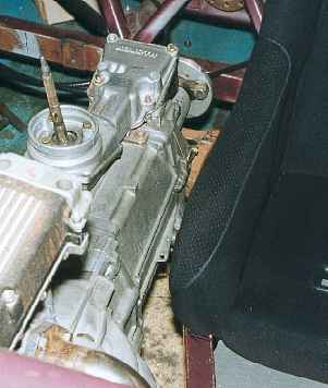 The passenger seat and gearbox close together.