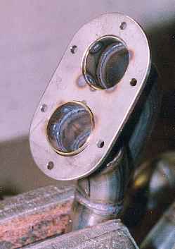 Flange with two pipes stuck through it.